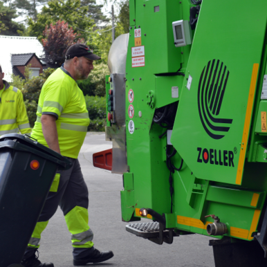 Twee ophaler rollen een DIFTAR container naar de ophaalwagen